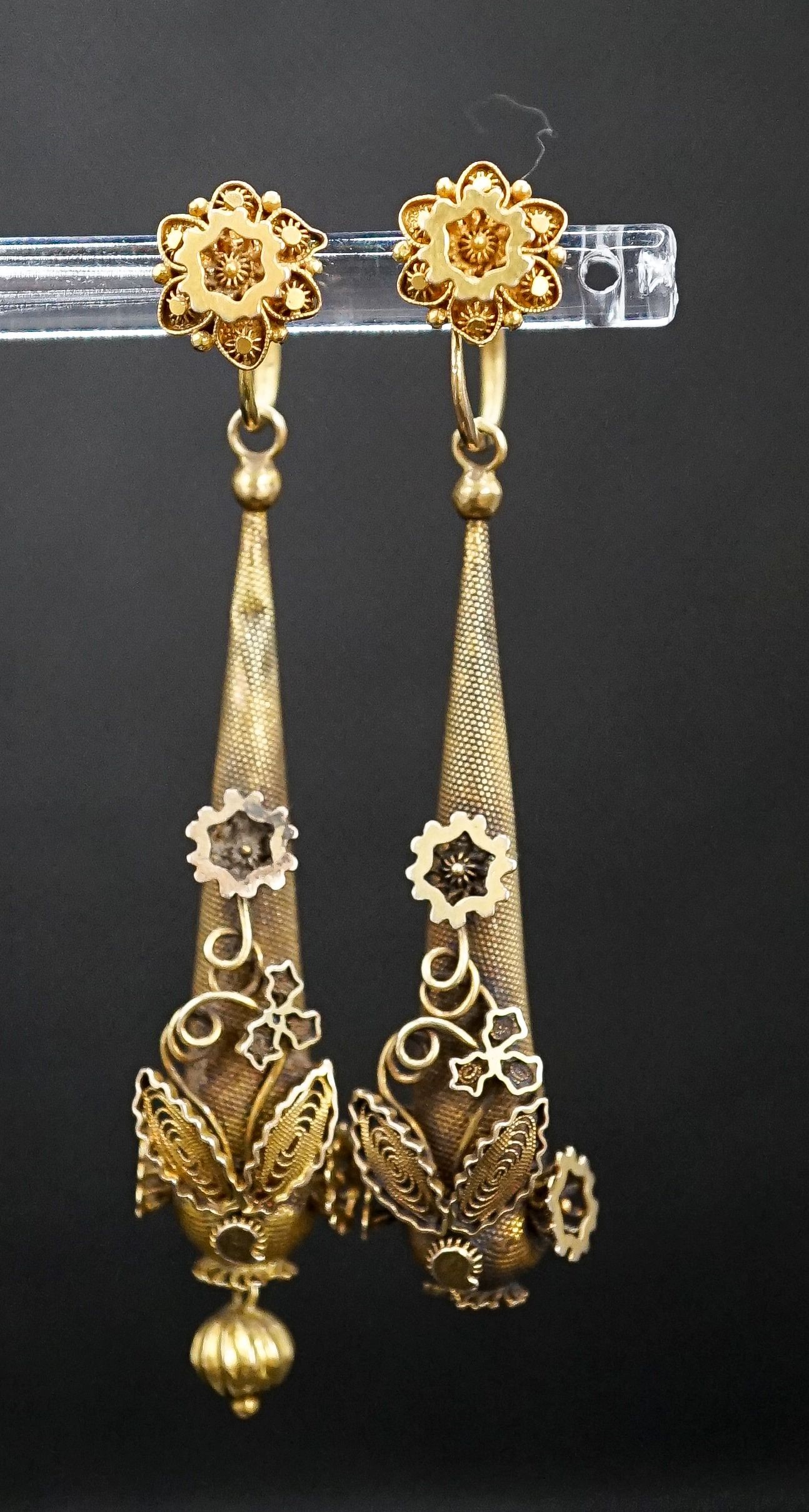 A pair of Victorian texture yellow metal pear shaped drop earrings, with star and foliate motifs(a.f.), 45mm, 5.8 grams.